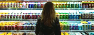 a meticulous shopper examines a vibrant display of supplement products, highlighted by dramatic lighting and vivid colors, symbolizing the journey of informed decision-making in the diverse and intricate supplement marketplace.