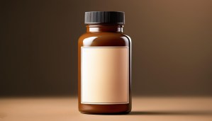 Brown medicine bottle with blank label on neutral background. white label supplements