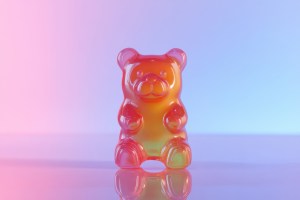 Close-up of a translucent gummy bear standing out among colorful gummy supplements, highlighting the texture and quality of gummy supplement manufacturing