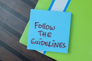 Sticky note with the handwritten message 'Follow the Guidelines,' emphasizing GMP Certification for Supplement Manufacturers to ensure compliance with industry standards and quality control