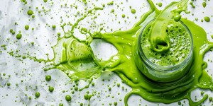 A vibrant green smoothie splashing in a glass, symbolizing freshness and high-quality nutrition, crafted by a trusted keto supplement manufacturer. 