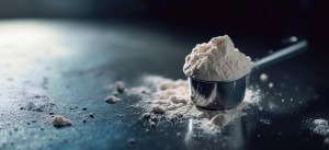 White powder in scoop, related to custom powder manufacturers and pre workout supplement manufacturers. Shows aspects of custom powder manufacturing.
