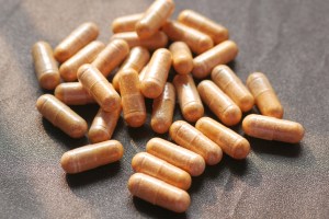 Herbal supplement capsules produced by capsule contract manufacturing, showcasing natural formulations in transparent vegetarian capsule shells.