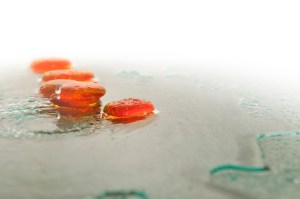 isolated wet zen stones with splashing water drops representing concept of natural balance and perfect harmony