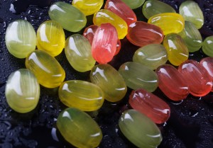 Lots of colorful candies. Multi-colored candies on a black background. Marmalade candies.